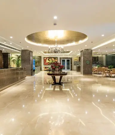 Stylish lobby at Good Earth Business Bay I, Gurugram, with elegant interior design, chandeliers, and comfortable seating for office visitors.