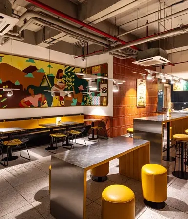 Modern interior of a restaurant at Good Earth Business Bay I, Gurugram, featuring contemporary seating and a welcoming atmosphere for customers.